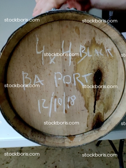 A cask oak barrel from its side.