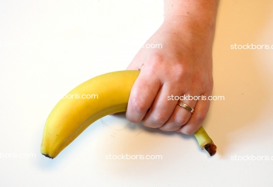 A hand holding a banana.