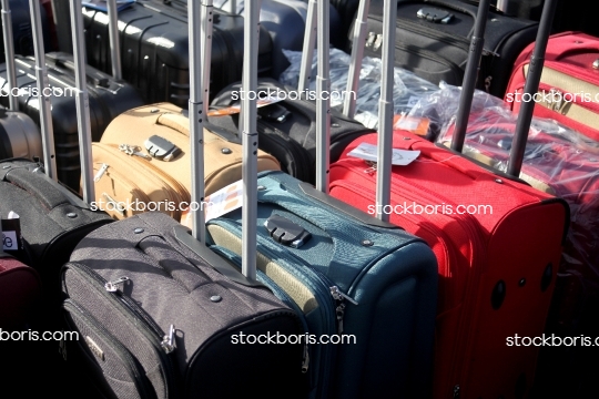 Black, blue, red and yellow suitcases and travel bags.