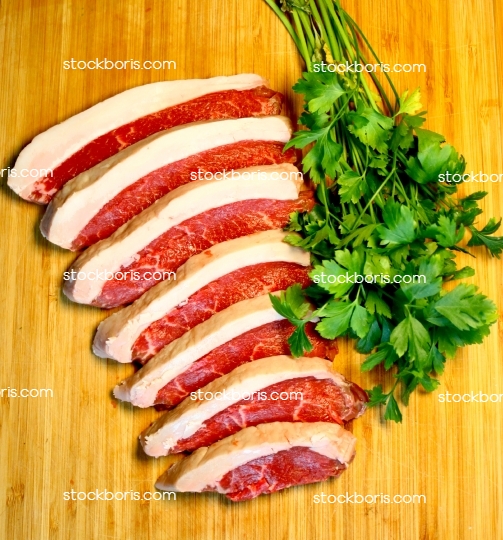 Delicious raw argentine rump steak slices with large fat