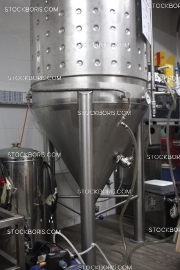 Fermenter and brewing equipment inside a craft beer factory.