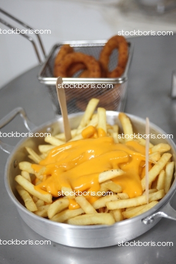 French fries with cheddar melted cheese and onion rings