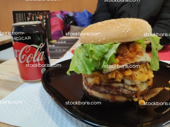 Hamburger with corn, eggs, cheese at fast food