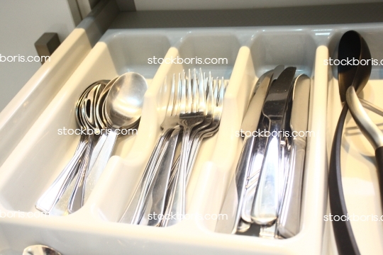 Kitchen drawer with spoons, forks and knives.