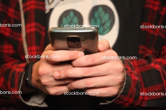 Man with a cell phone in his hands.