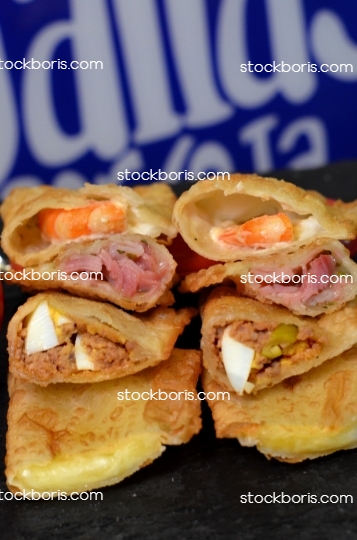 Opened Brazilian plastry. Prawns, ham, meat and eggs and cheese pastry.