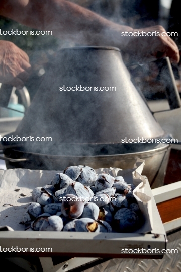 Roasting portuguese chestnuts with smoke.