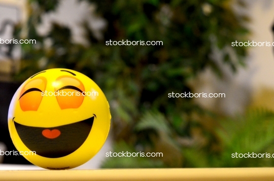 Smile, happiness, good mood. Yellow smiling toy.