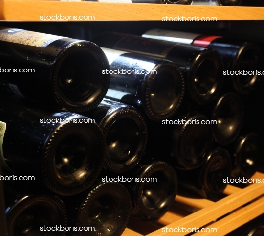 Wine bottles laid in a cellar.